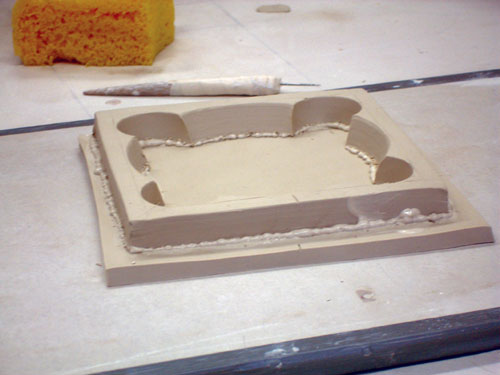 Fig.4 Attaches the footwell to the slab. After the piece has set up, use a Surform to clean up the form.