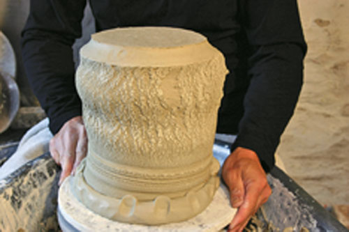 Clever use of a soft coil applied to a leatherhard rim allows the pot to be inverted on the wheel for trimming.