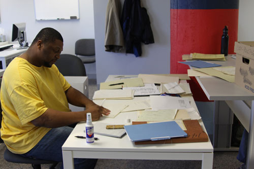 Army veteran Sean Box cleans and mends documents associated with an archaeological investigation. The records management skills Sean learned while at the VCP helped him gain employment as a file clerk with Veterans Affairs.