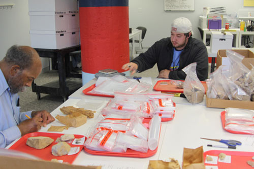 Army veteran Conway Slaughter (Left) and Marine Corps veteran Kurt Walther (Right) analyze and rehouse artifacts in the St. Louis VCP facility.