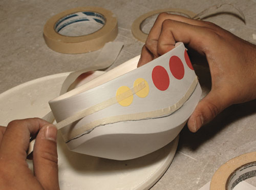 Fig.10 Decorate the bisqued bowl using masking tape and stickers before glazing.