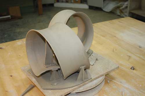 Custom clay supports are made for each piece so it remains supported during firing.