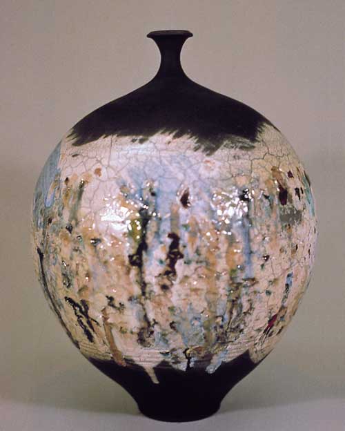 Vessel, 20 inches high. Embedded glass technique glazed with Rogers White with brushes of Del Favero Luster glazes. Slight post-firing reduction. By Steven Branfman.