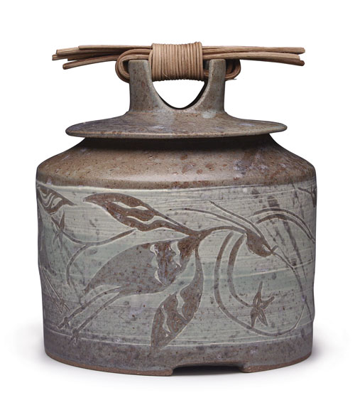 Storage jar with herons, 8 in. (20 cm) in height, wheel-thrown dark stoneware with illustrations carved into white stoneware slip, and-woven reed handle, by Mea Rhee.