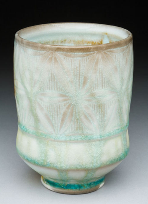 Adam Field’s cup, 5 in. (13 cm) in height, porcelain with carved pattern and celadon glazes, soda fired to cone 11 reduction, 2010. Photo: George Post.