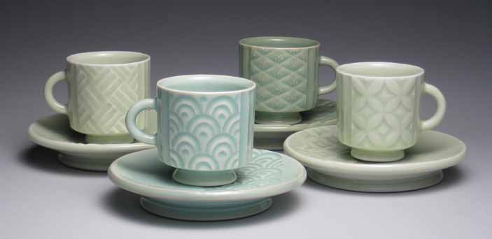 Teacup set, featuring four carved patterns: woven, wave, diamond, and floral. All patterns were made with the help of a grid overlaid onto the leather-hard porcelain. The pieces were coated with celadon glazes and fired to cone 10 in reduction, 2014.