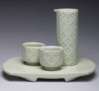 Floral-patterned sake set, wheel-thrown, carved, and slip-trailed porcelain, celadon glaze, fired to cone 10 in reduction, 2014.