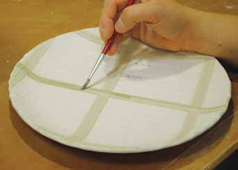 13 After slip trailing and cleaning up the edges of all of the lines, apply a wax resist over the glazed surfaces.