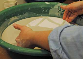 14 After the wax resist dries, apply a clear glaze to the remainder of the surface.