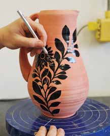 2 Apply the stencils and trim overlapping areas to help the leaves and flowers pop from the surface.