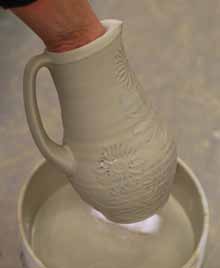 5 Once the pitcher has dried from the sponging, glaze the interior, then dip the exterior in a cone 10 satin-matte glaze.