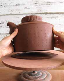 12 Attach the base to the pot and trim any excess clay around the exterior.
