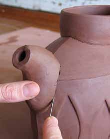 10 Mark where the spout will attach, cut holes and join it to the pot.
