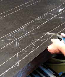 3 Transfer the brown paper patterns to tar paper using a white pencil, then cut them out with scissors.