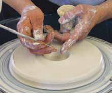 1 Center and flatten 3 pounds of clay into a disk. Open the center to a thickness of about ¼ inch.