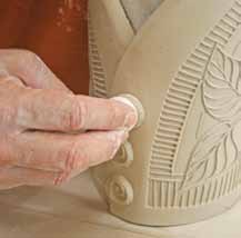 6 Add buttons of clay over the seam to add visual interest and reinforce the seam.