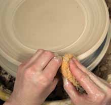 2 With your thumb under the clay and your fingers on top, pull the rim out and up.