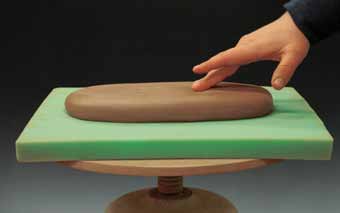 1 Throw a slab of clay approximately 1½ inches thick with the basic footprint of the form.