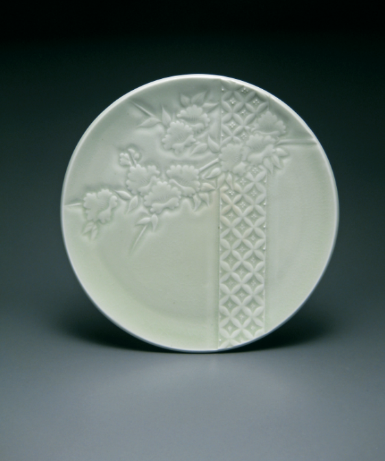 Cherry Plate, wheelthrown and altered porcelain, carved and trailed patterns, celadon glaze, fired to cone 10 in reduction.