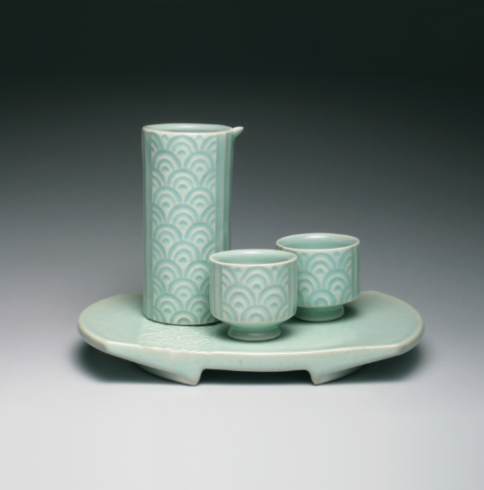 Yoshi Fujii’s Sake Set, featuring circle pattern, wheelthrown and altered porcelain, carved and trailed patterns, celadon glaze, fired to cone 10 in reduction, 2014.