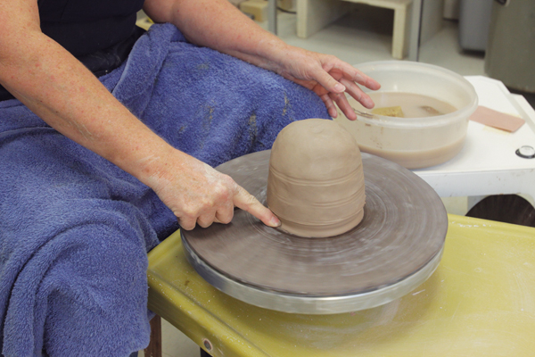 10 Seal the mound to the wheel head by creating a small buttress of clay.
