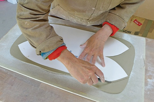2. Cut the slab approximately ½-inch larger than the cardboard template. Bevel the V-shaped ends at a 45° angle.