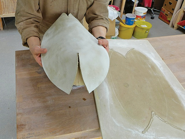 3. Score and slip the bevels, place the slab onto the mold, then shape it to the form.