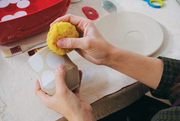 7. Apply the stencils and make sure they’re secure by patting them down with a damp sponge or your fingers.