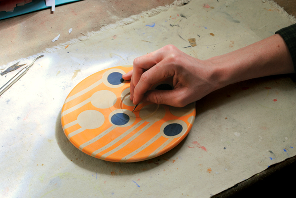 12. Coat all decorated surfaces in wax, then use an X-Acto blade to carve lines into the clay through the dry wax.