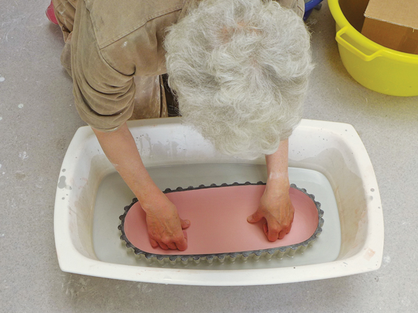 15. After glazing the interior, push the bowl down in to a vat of glaze up to the rim to coat the exterior.