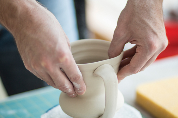 11 To create a more natural drinking area, stretch the rim of the cup into an oval form. Place the mug on a drywall board and wrap tightly over night. The next day, use a cosmetic sponge to remove any unwanted marks. After finishing, allow the mug to dry slowly and evenly for a couple of days. 7–11 Photos: Eliot Dudik.