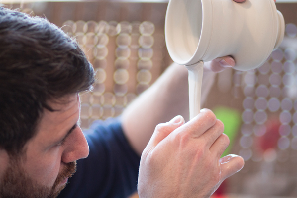 5 After attaching the top of the handle to the mug, begin pulling, making sure the handle hangs straight down during the process.