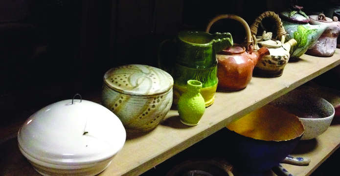 surrounded by functional pottery-695