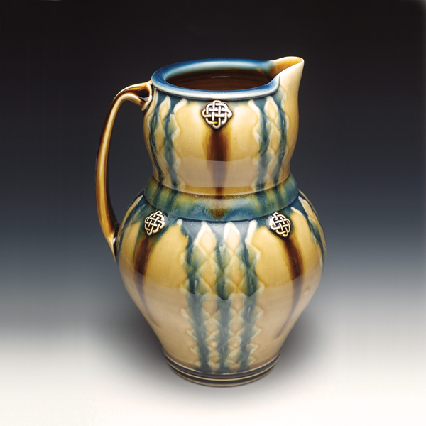 Ryan Greenheck's Blue-Brown-Honey Pitcher, 2007, 10 inches in height, wheel-thrown porcelain, stamped appliques, glaze-trailing and wax resist, cone 10 oxidation. Photo: Ryan Greenheck