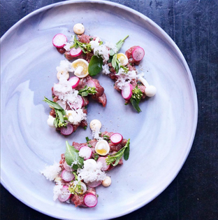 Chef Eli Kulp’s venison tartare, pickled beech mushrooms, radish and broccoli root.