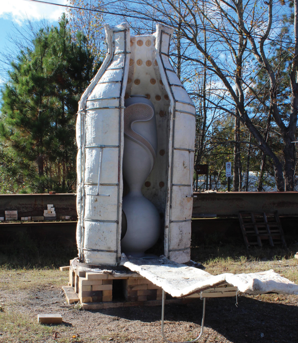 Loading Ibrahim Said’s work into the petal kiln.