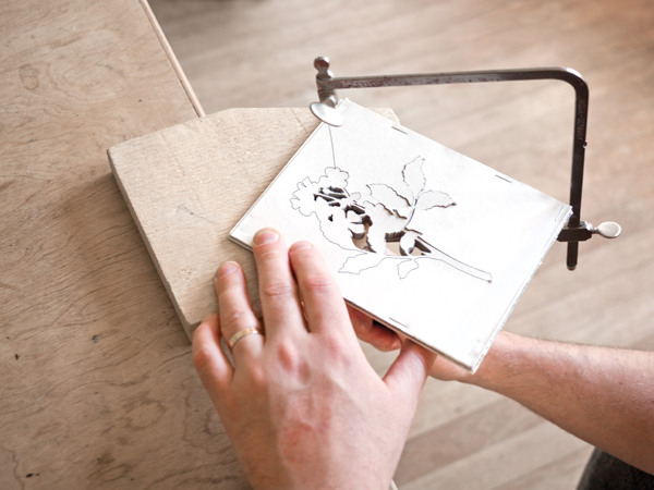 1 Cutting paper resist illustrations with a jeweler’s saw.