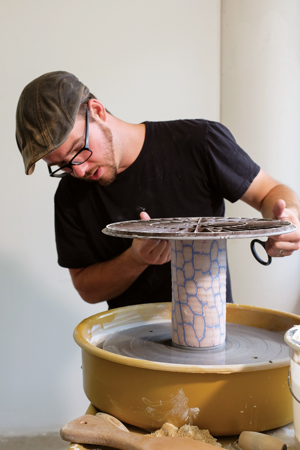 4 Attaching the cylinder to a separately thrown base. Leaving the cylinder attached to the bat during this process keeps the surface of the colored clay from being smearing, because the bat is handled rather than the piece.