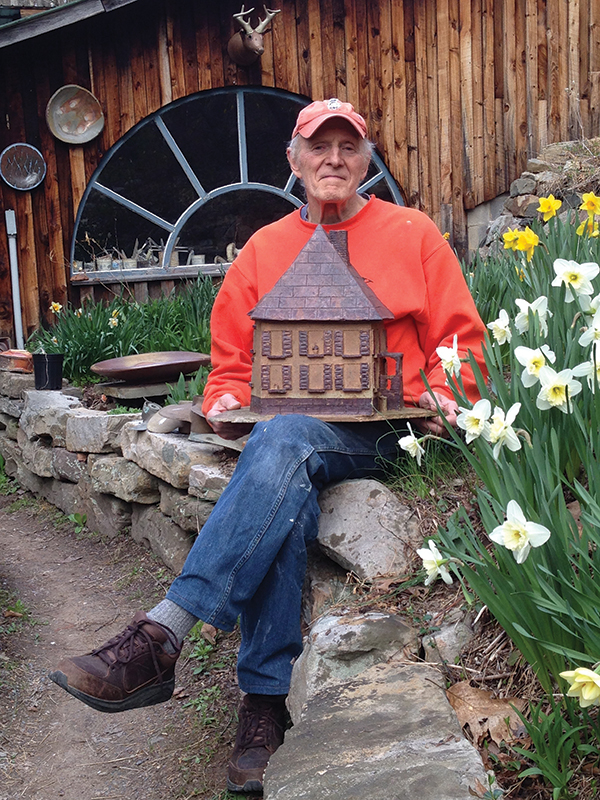 Jack Troy, pictured with a model of a house built by Valerie Myer, a German exchange student he taught at Juniata College. Photo: Carolanne Currier.