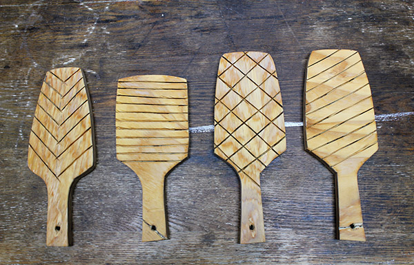 2 Use a Dremel tool with a cutting bit to carve geometric patterns into pre-cut paddles.