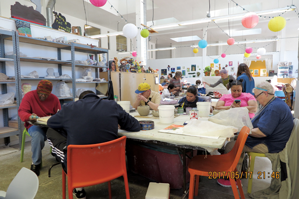 A group of artists working at Creative Growth Art Center in Oakland, California.