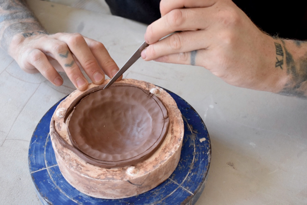 4 Cut off the excess clay, being careful to leave some extra at the connection points to ensure a solid and strong seam when the mold pieces are assembled.