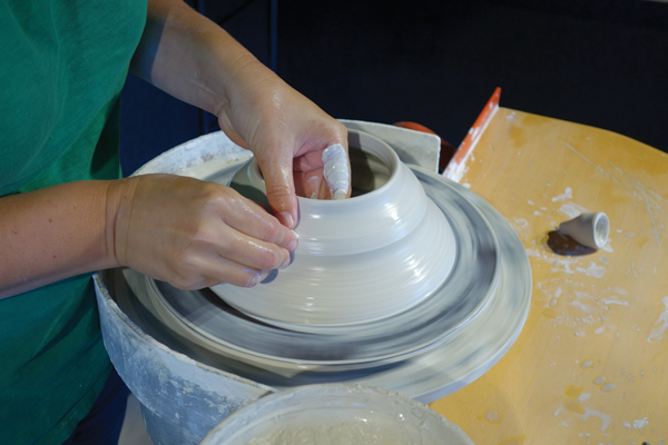 2 Develop a funnel shape and slowly start to collar in the cylinder until it closes in at the top.