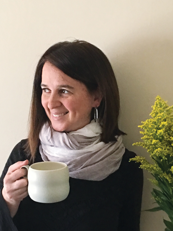 4 Carreño at her home holding her Cloud Mug, 4 in. (10 cm) in height, porcelain, moss glaze, fired to cone 6 in oxidation.