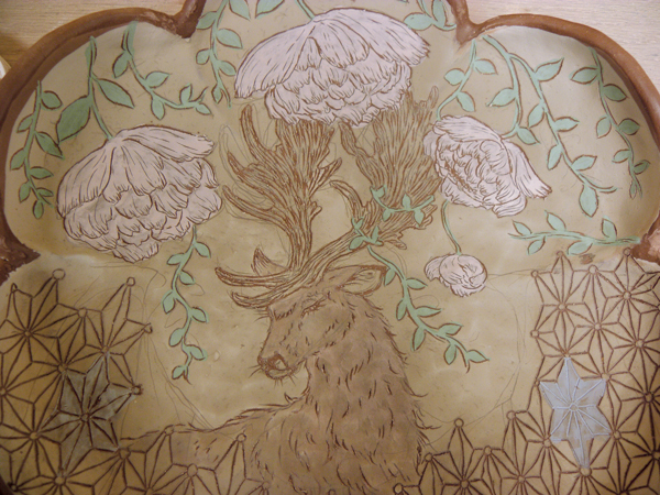 C Carve in the details on both the flower and animal subjects using a sharp pin tool.