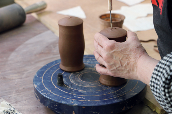 16 Use a hole cutter to create shaker holes in the domed top. Create a different number of holes in each shaker.