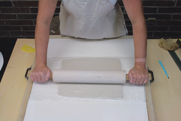 4 Use a rolling pin to roll a sheet of bubble wrap over one of the large slabs.