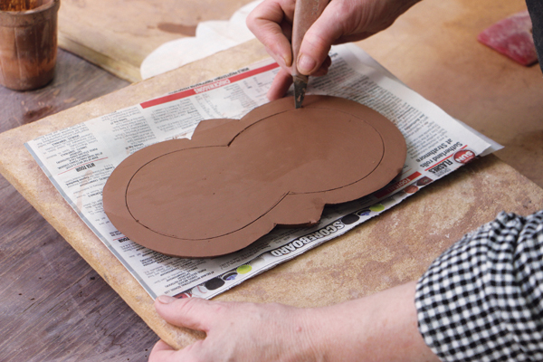 5 Cut the center piece out of the base’s top slab. Angle the blade for a beveled cut. Cut lightly into the second slab layer.