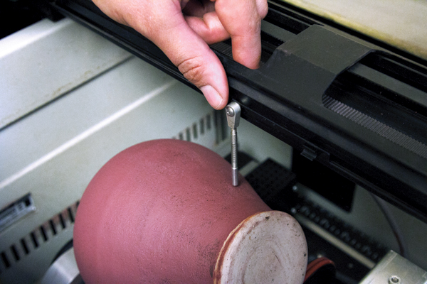 8 Setting the correct focus. The floor of the laser etcher is adjusted to bring the jar into the correct focus range and the rotary attachment is adjusted to ensure the print surface is horizontal to the laser. 