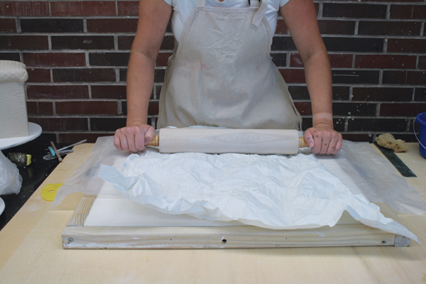 9 Roll crumpled paper on top of the remaining large slab to add texture.